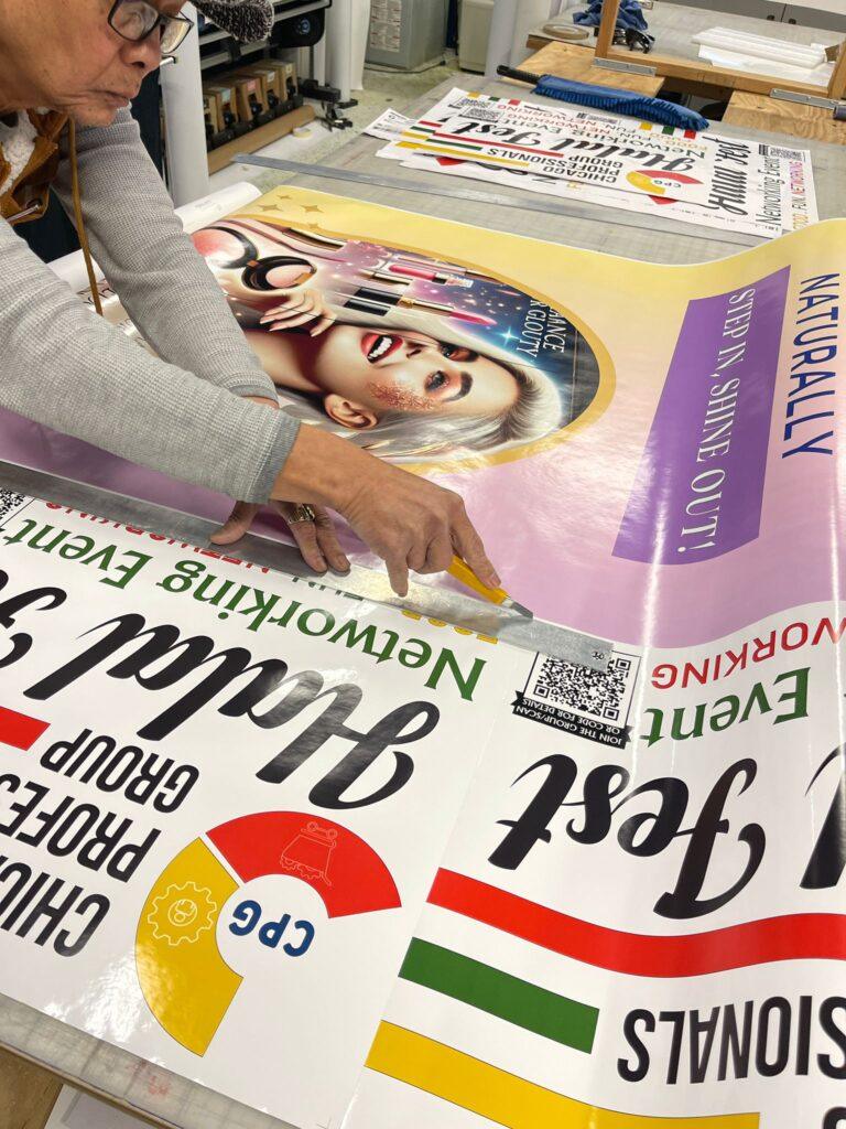 Large-format banner prints coming off the press at Sign America in Niles