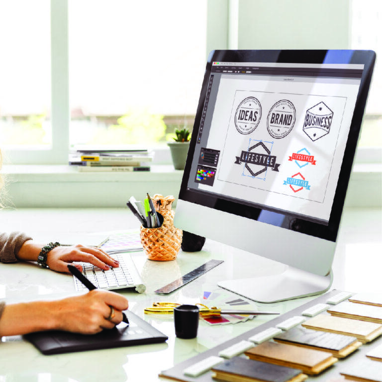 Designer preparing print-ready artwork at Sign America