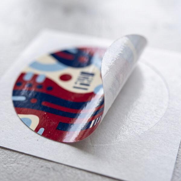 Close-up of a round sticker peeling from its backing — Sign America Chicago
