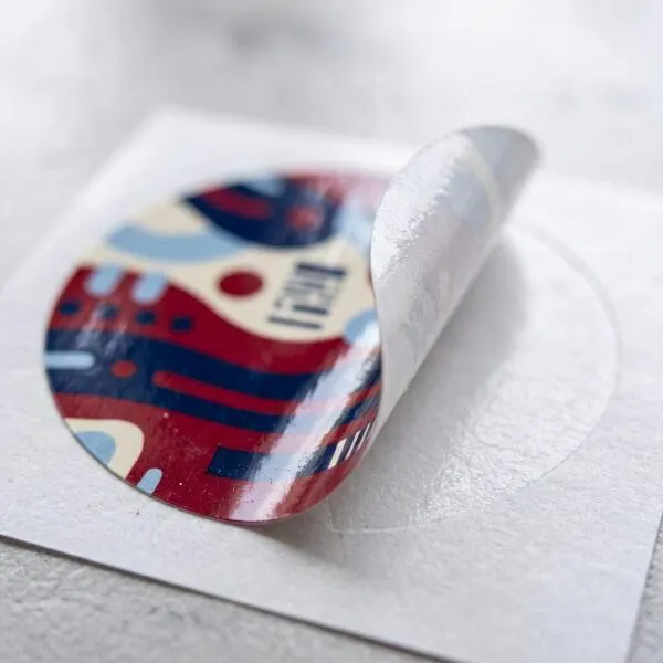 Close-up of a round sticker peeling from its backing — Sign America Chicago