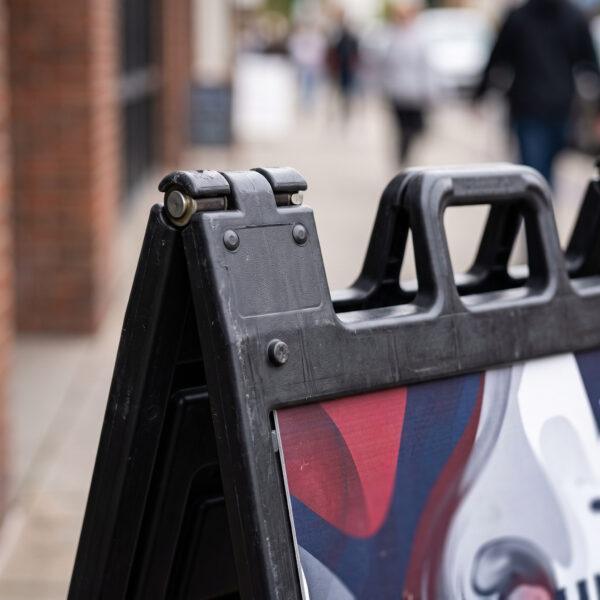 Close-up of A-frame sign hinge, handle and panel slot — Sign America Chicago