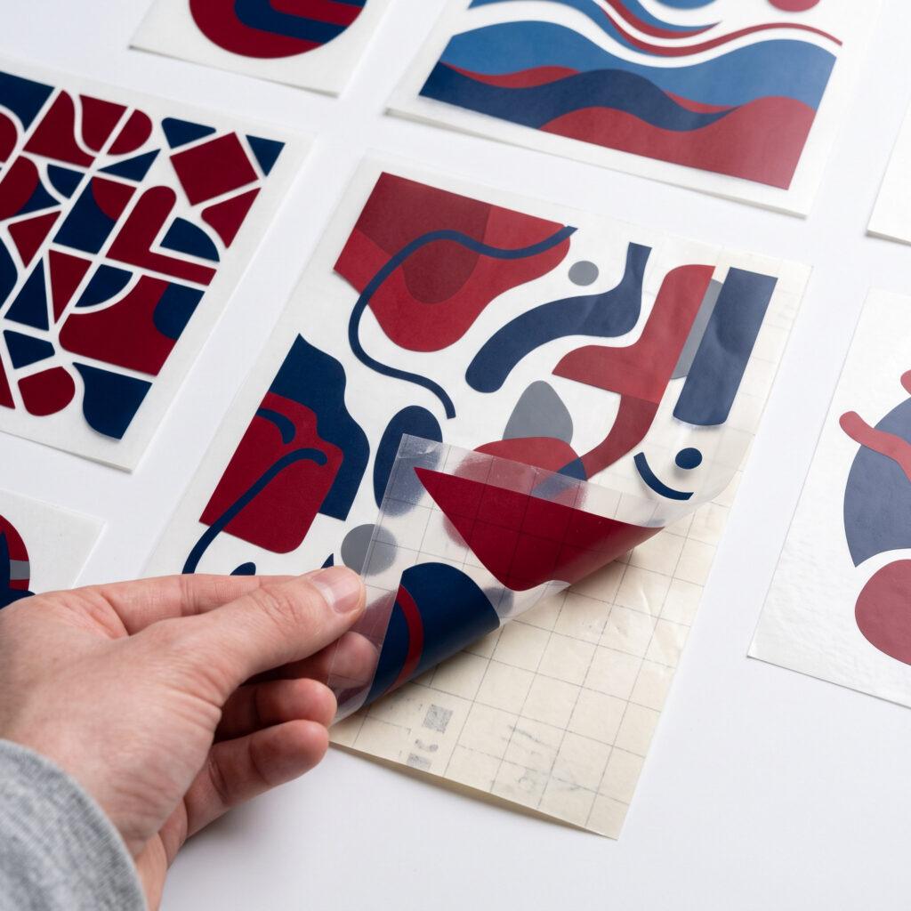 Adhesive vinyl window decals with backing paper on studio background — Sign America Chicago