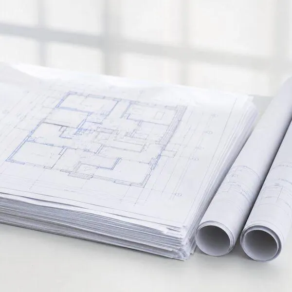 Contractor reviewing printed plan sets on the job site — plan printing Sign America Chicago