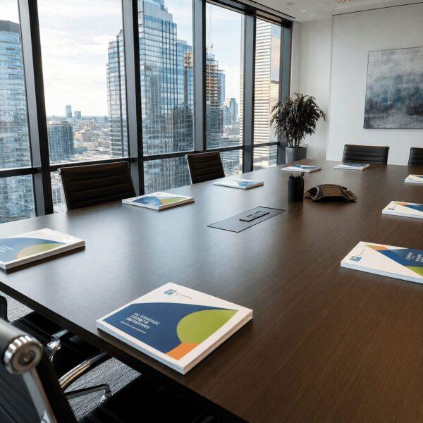 Collated color handout packets on a conference table — document printing Sign America Chicago