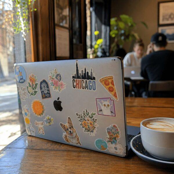 Laptop covered in colorful die-cut stickers — custom stickers Sign America Chicago